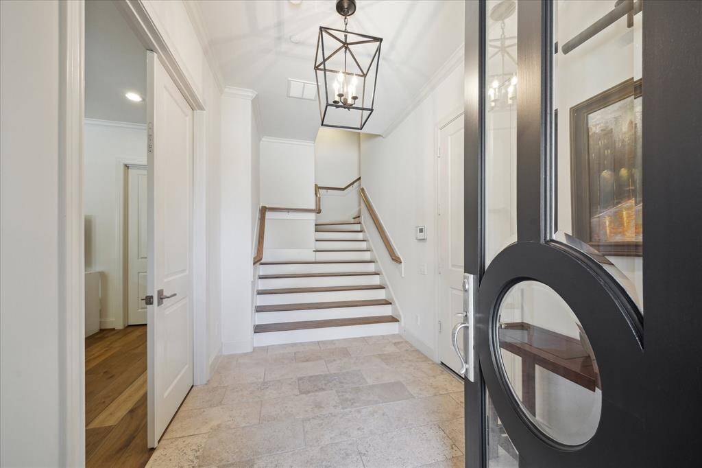 To the left is the first floor secondary bedroom with french doors opening to the fornt yard.