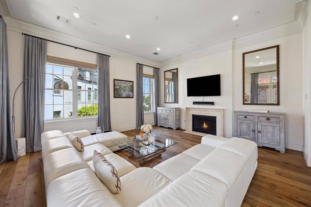 This view of the kitchen and dining area highlights the high-end cabinet finishes, with a custom wine rack and built-in shelving for cookbooks nestled in the alcove.