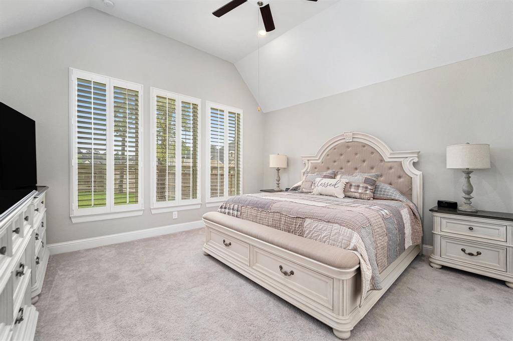 Fabulous primary bedroom with high ceilings, overlooks the backyard, and has a private en suite.