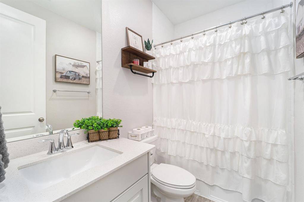Secondary bathroom with a combination tub and shower.