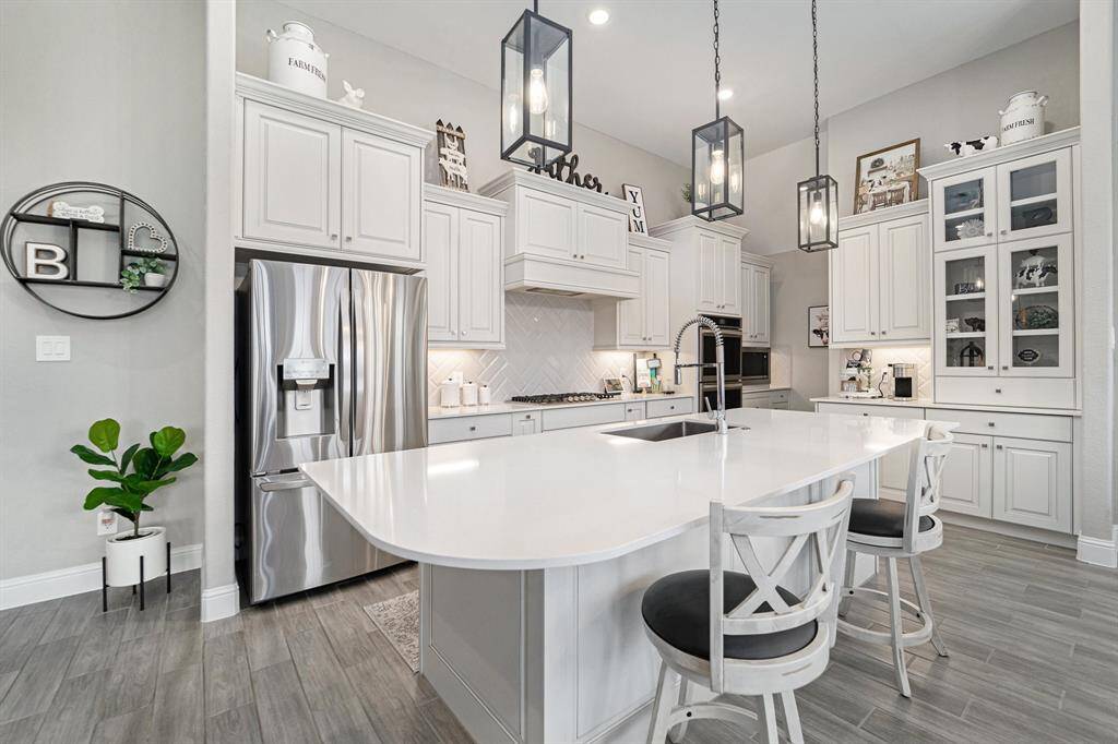 Chef's dream kitchen presents dual ovens, tons of cabinet space, a massive island, and a huge walk-in pantry.
