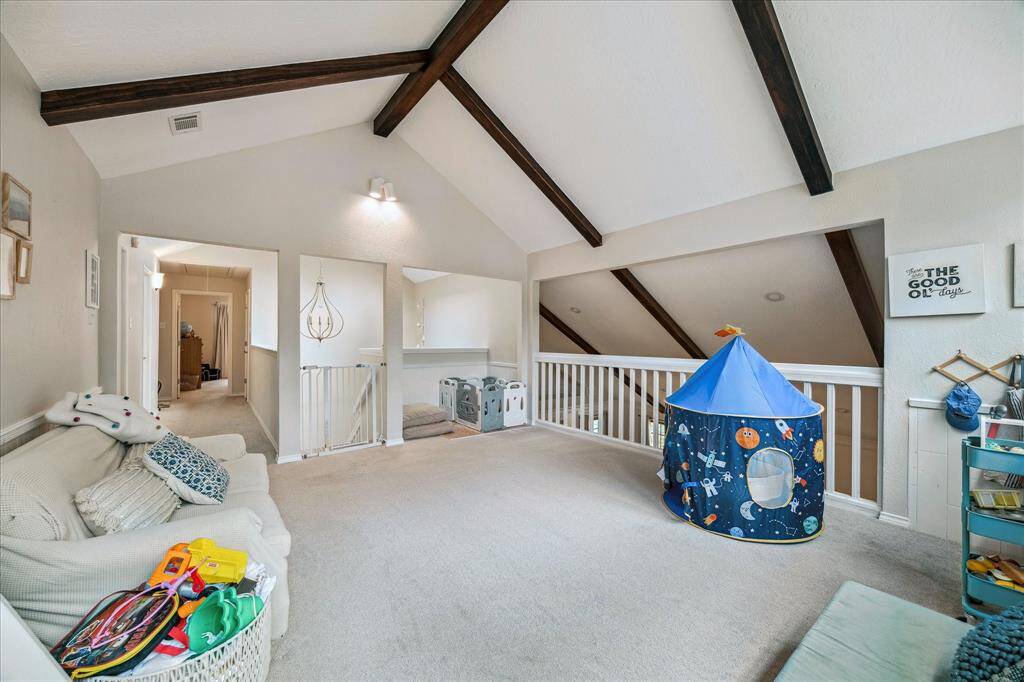 This view taken from the corner of the second floor game room shows the hallway that leads to the three secondary bedrooms and full bath.