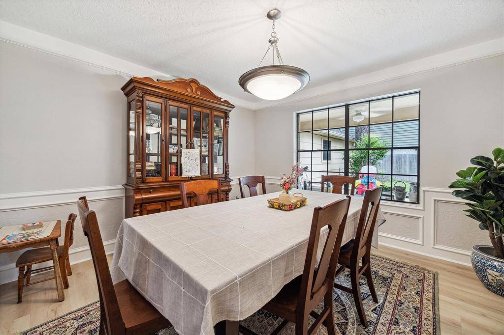 The formal dining room, highlighted by mid-wall decorative molding plus crown molding, has views of the backyard and is open to the entryway and connecting hall joining the family room and kitchen area. This dining room could make a nice private study should a homebuyer prefer.