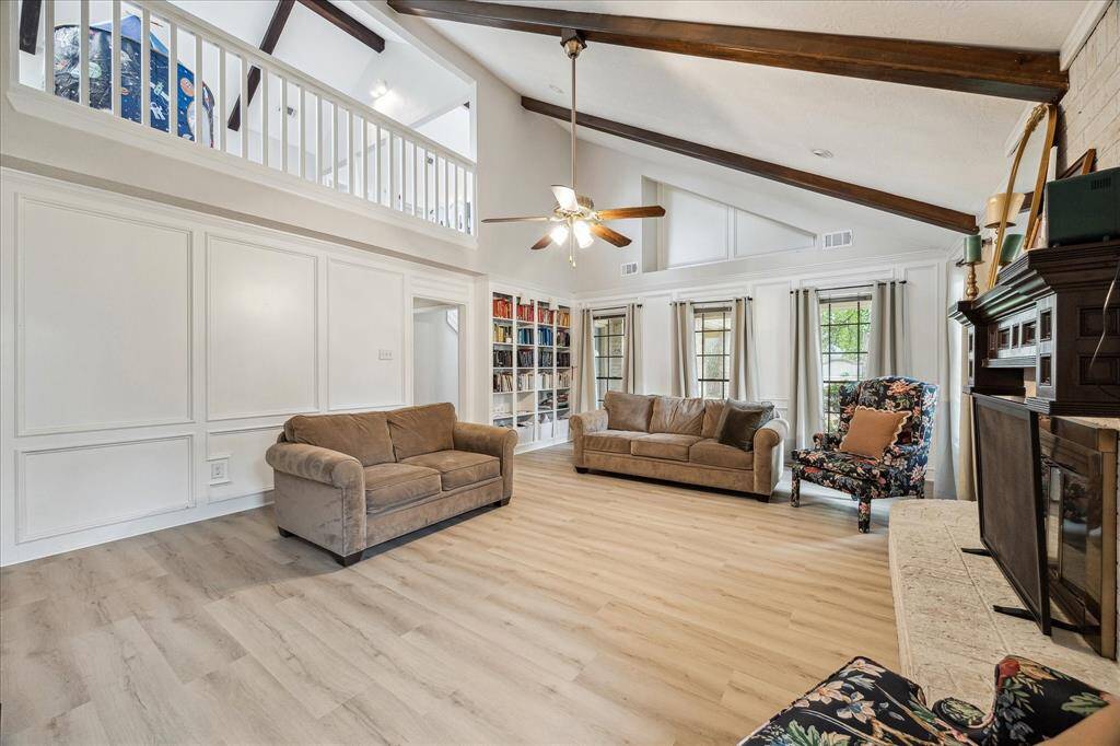 Another view of the family room showcasing the loft-style game room on the second floor.