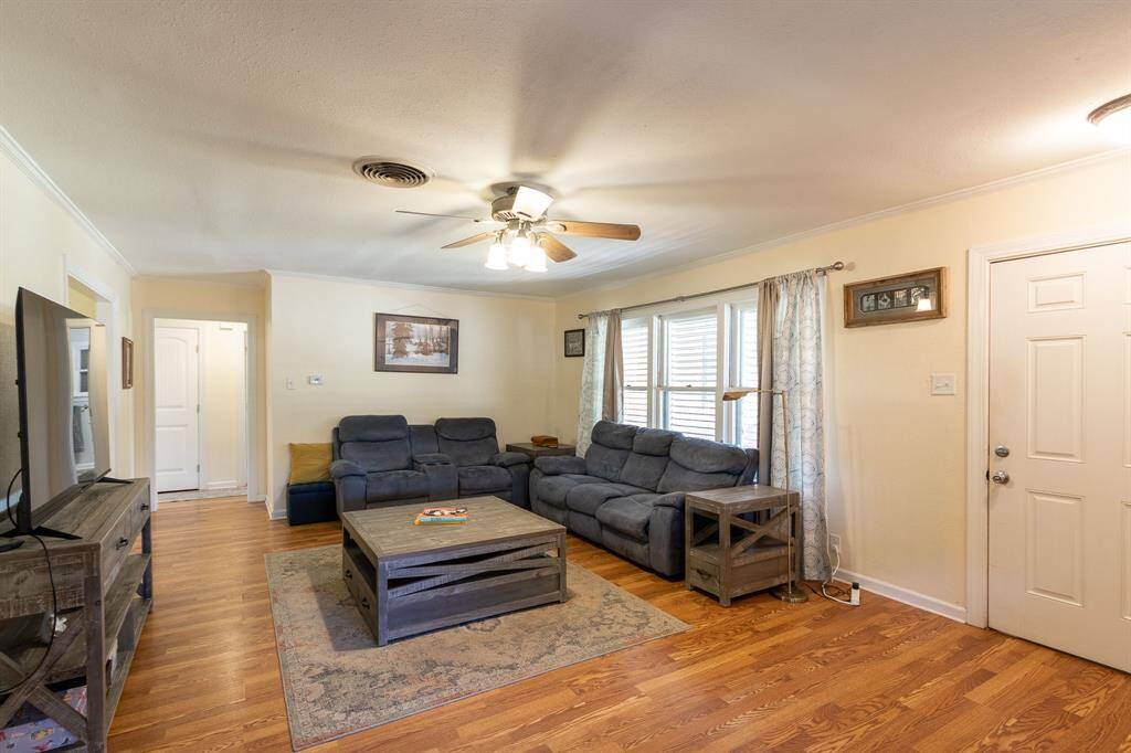 Large living room. Hallway to two bedrooms and hall bath in the background.  Front door to the right.