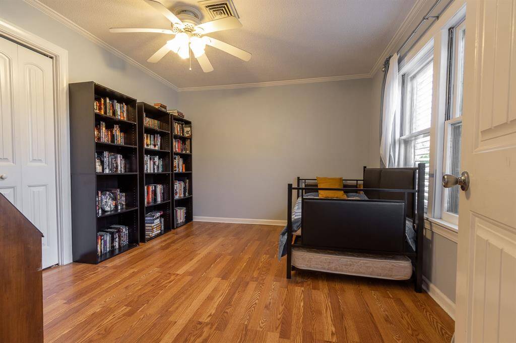Looking from the dining area into the third bedroom, also serving as a home office.  Closet to the left.