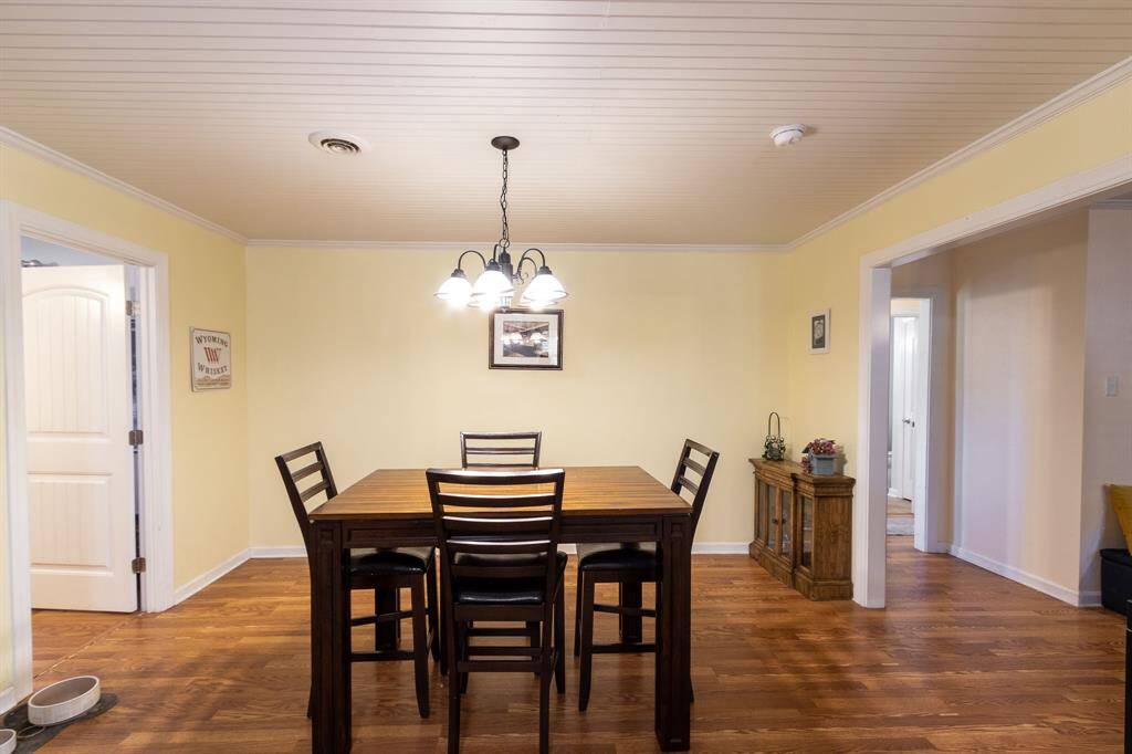 Dining area with third bedroom/home office to the left and hall way to two bedrooms to the right.