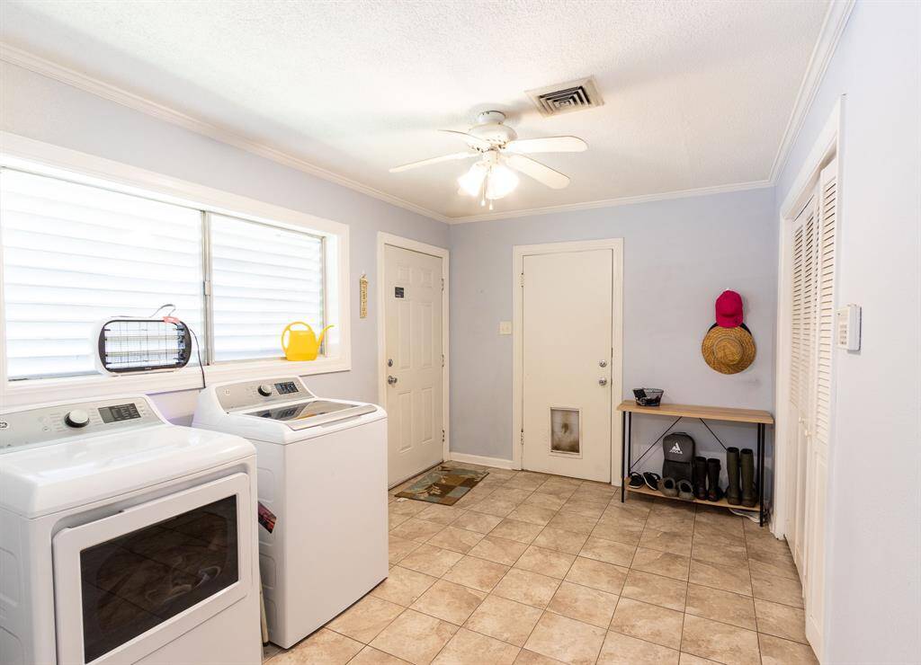 Large utility room with washer and dryer to the left. Door to the driveway next to the washer & dryer. Door against the back wall goes to the garage. Large closet to the right.  Washer and dryer do not stay with the house.