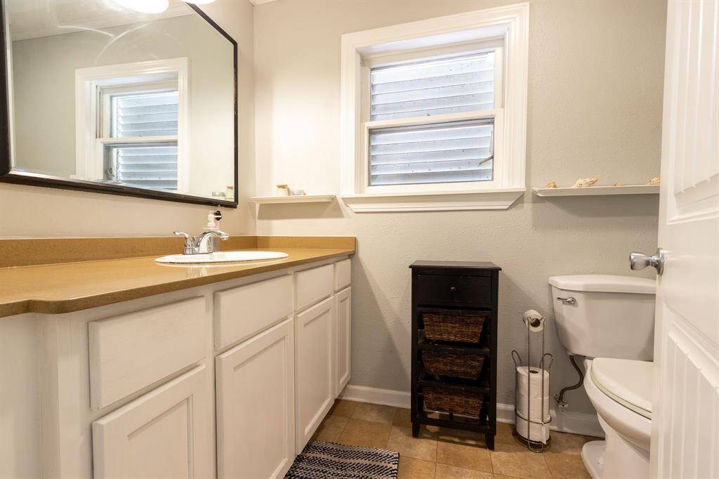 Ensuite bath for the primary bedroom has a large vanity.