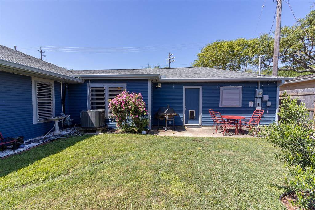 Fenced backyard with patio. To the right is the walkway to the driveway and Marine Drive. Door at the patio leads into the two car garage.