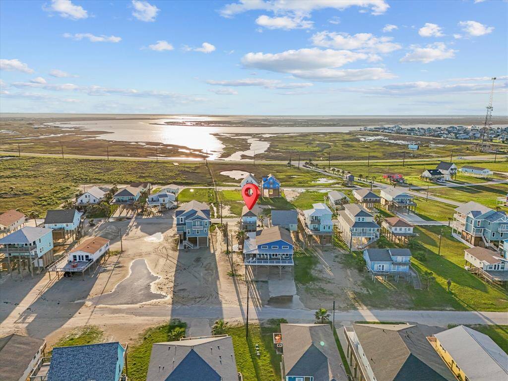This photo showcases a charming coastal neighborhood with elevated homes, providing scenic views of nearby water and marshlands. Ideal for those seeking a serene, picturesque setting.