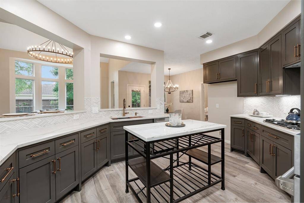 This kitchen has stunning quartz counters throughout and provides great views into the living room!