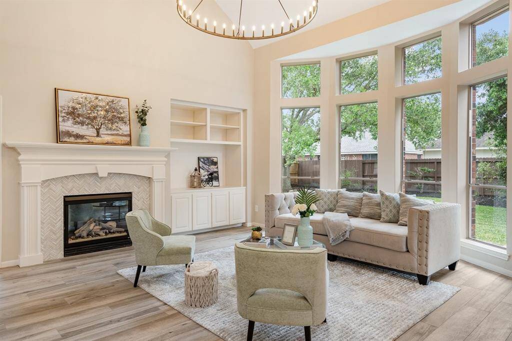Its time to relax in this STUNNING living room! Soaring ceilings and a wall of windows create a bright and peaceful atmosphere!