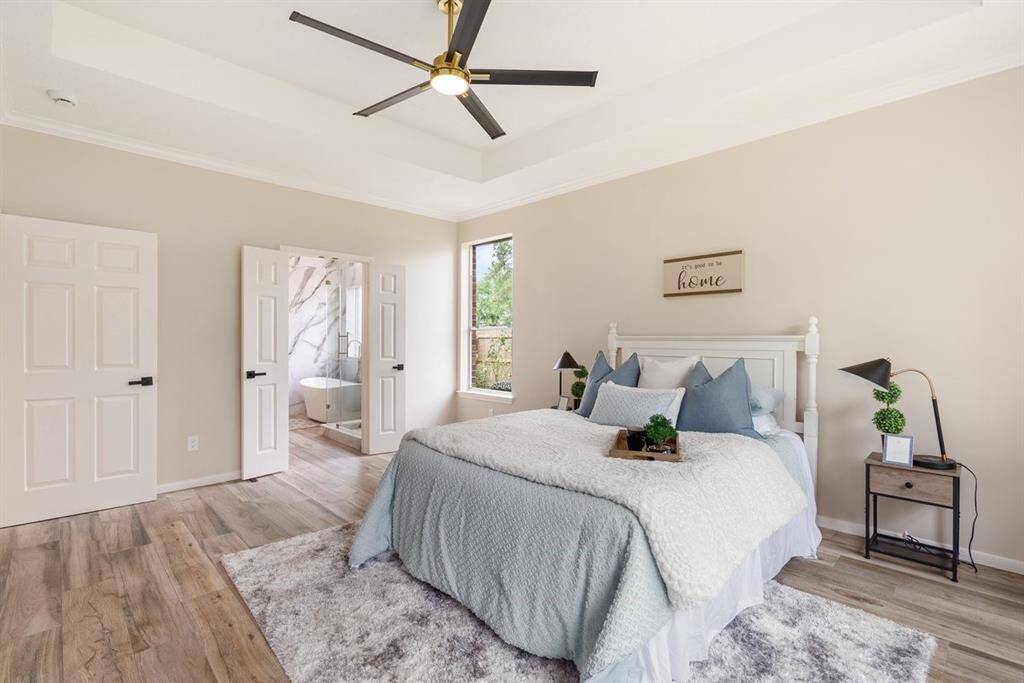 The primary suite is the place to relax! Enjoy high ceilings and easy to maintain wood tile throughout this great space!