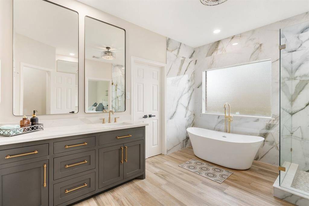 Who needs to go to a spa when your primary bathroom looks like this?! Gorgeous floor to ceiling tile and double vanities with golden handles create a luxurious feel!