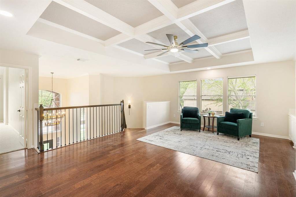 Bring on the fun in this cozy game room with built in cabinetry! Coffered ceilings provide a sophisticated look to this spacious area!