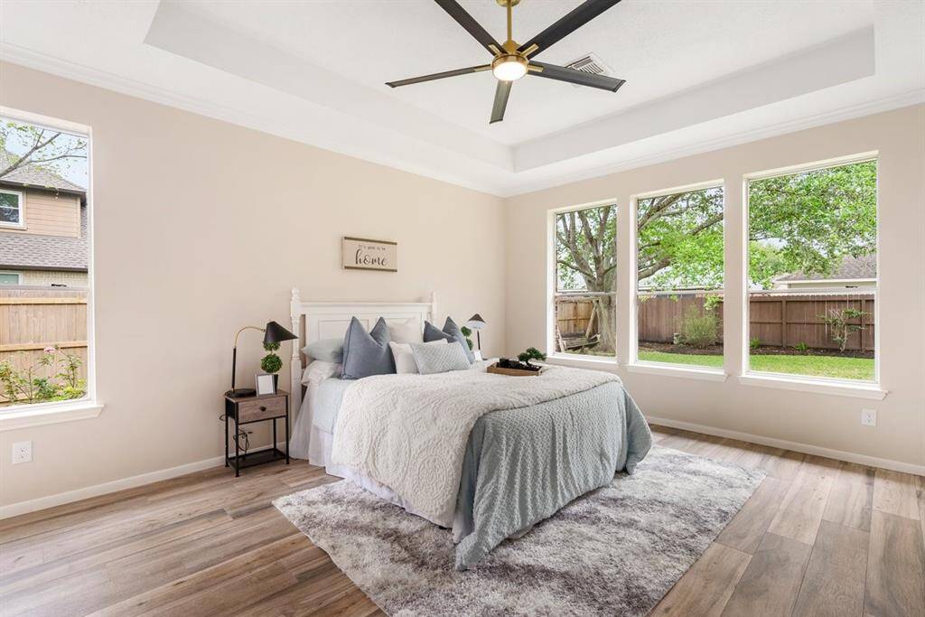 Wake up feeling refreshed in this spacious primary suite! Enjoy tranquil views of the luscious backyard!