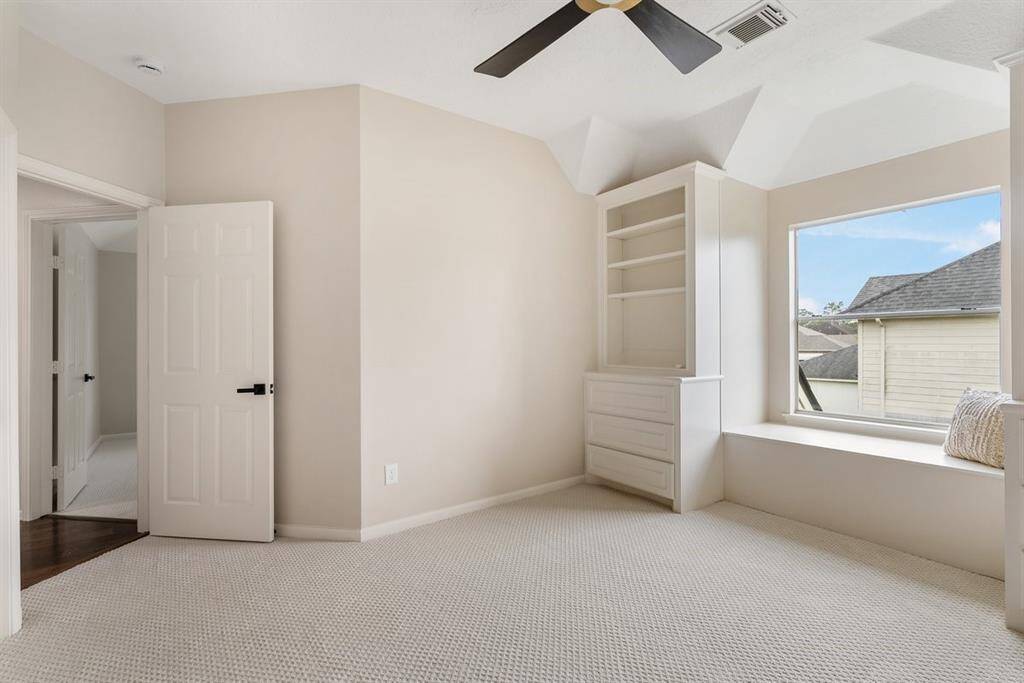 Three secondary bedrooms are upstairs! This beautiful room has built in shelves and banquet seating!