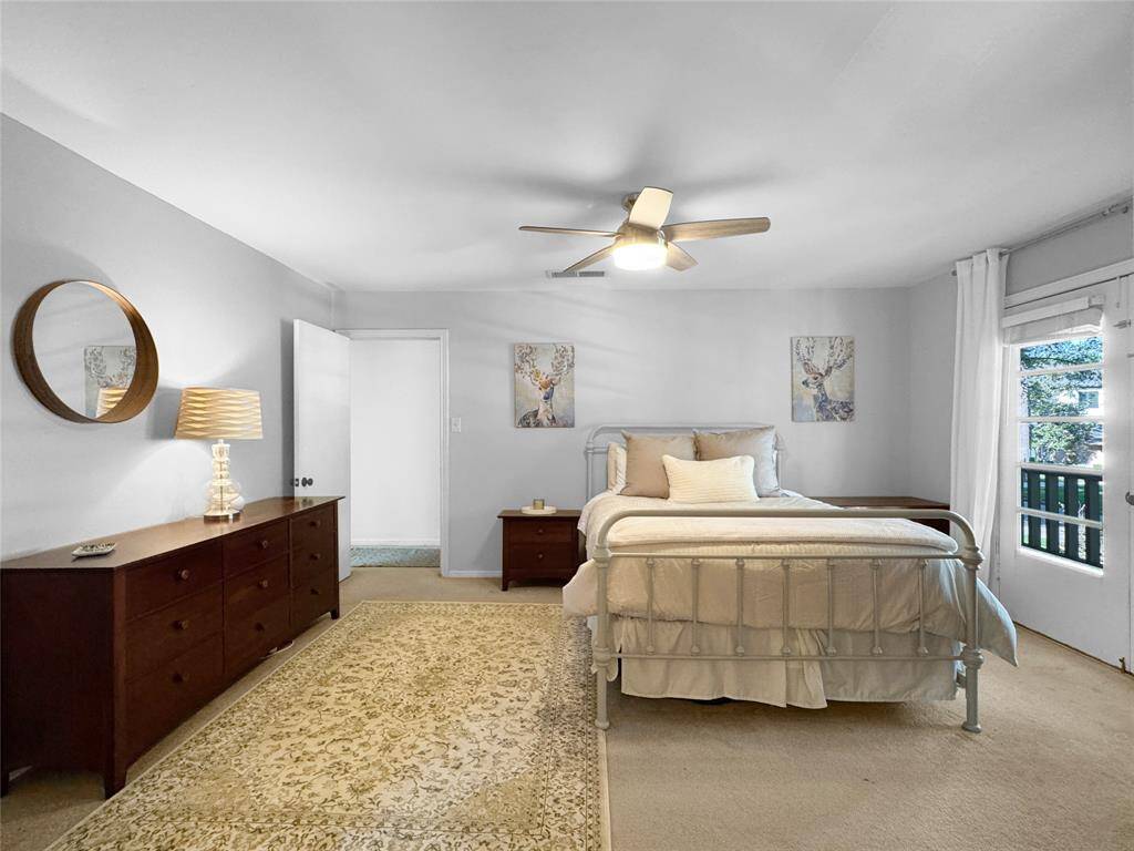 Primary bedroom on second floor, with access to front balcony.