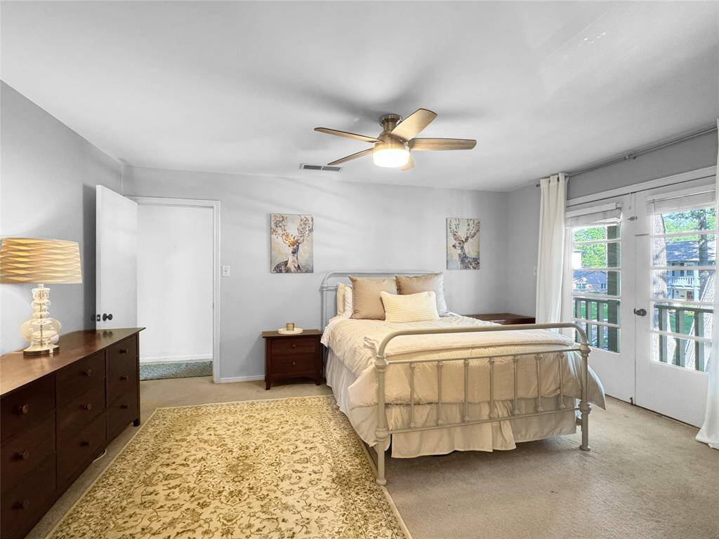 Primary bedroom on second floor, with access to front balcony.