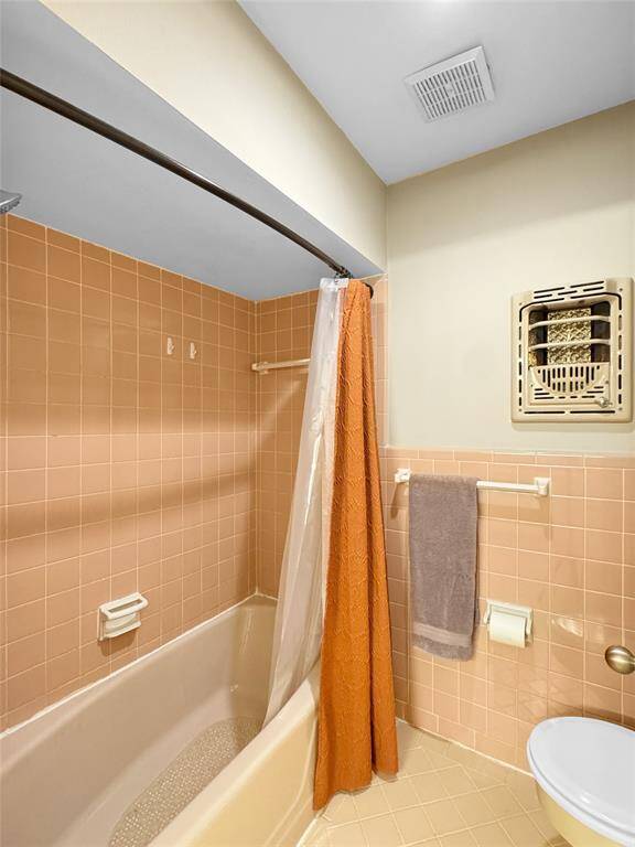 Second bathroom shower and toilet area.