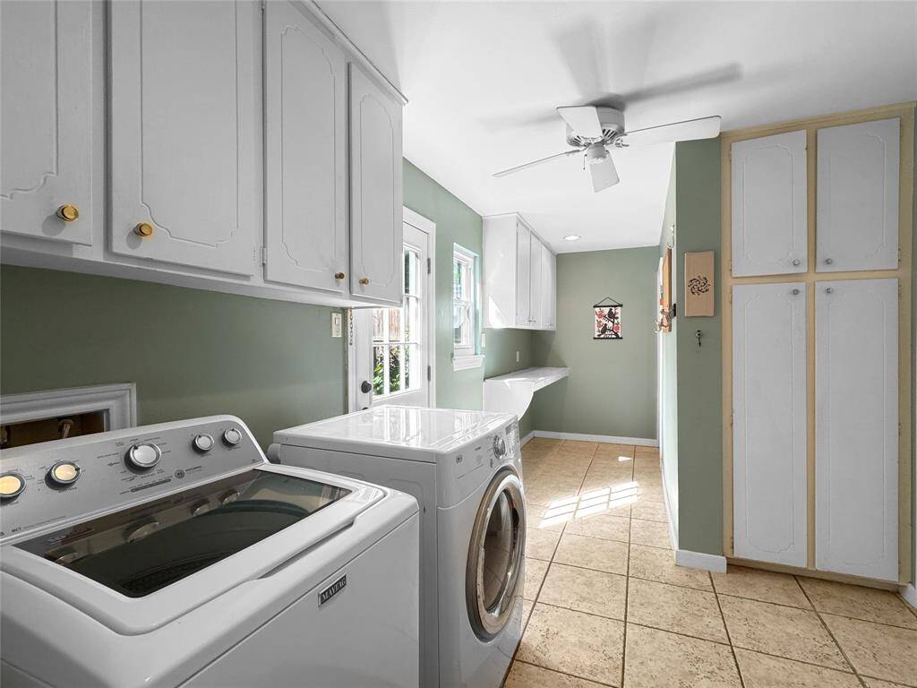 Huge utility room connecting the kitchen and garage entry.  Door to back yard.