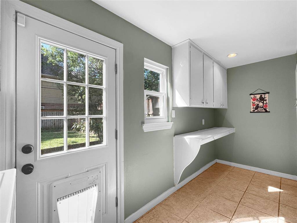 Huge utility room connecting the kitchen and garage entry.  Door to back yard.