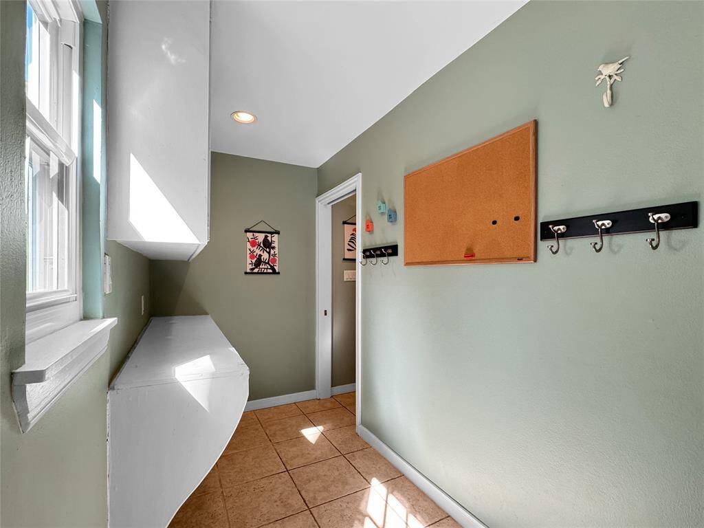 Huge utility room connecting the kitchen and garage entry.  Door to back yard.