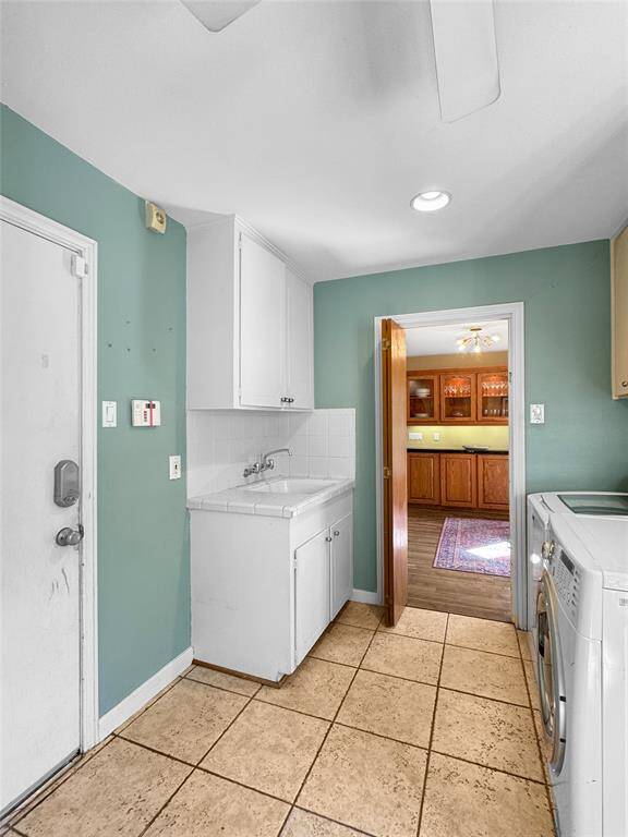 Huge utility room connecting the kitchen and garage entry.  Door to garage. Full utility sink.