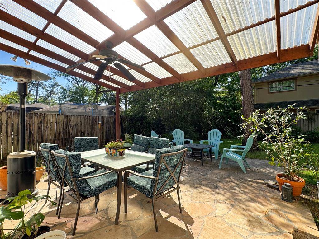 See through covered patio overlooking lush back yard.