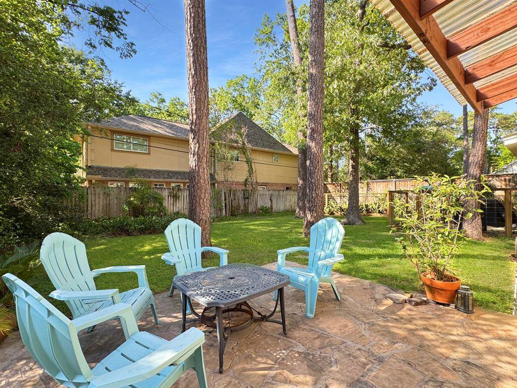 Sitting area overlooking lush back yard.