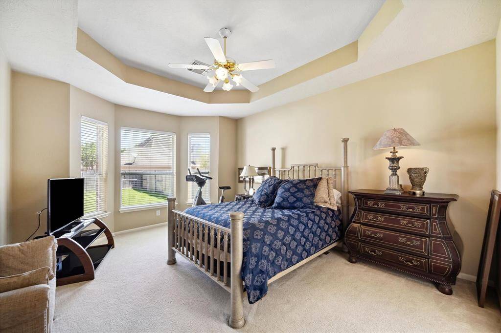 MASTER BEDROOM RETREAT WITH BAY WINDOWS AND TIERED CEILING.