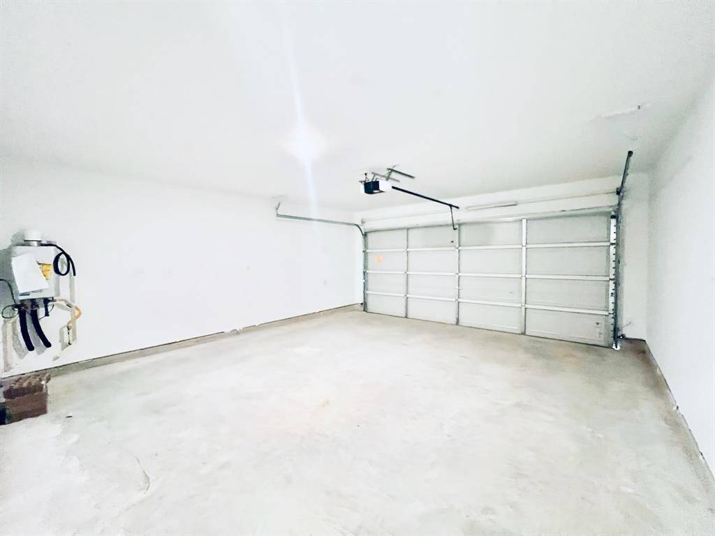 Garage features a tankless water heater and remote garage door opener