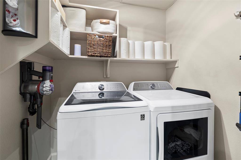In-house utility room with extra shelving to hold all of your laundry and cleaning needs!