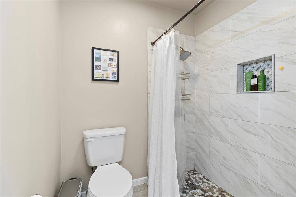 Your primary walk-in shower with stunning tile work!