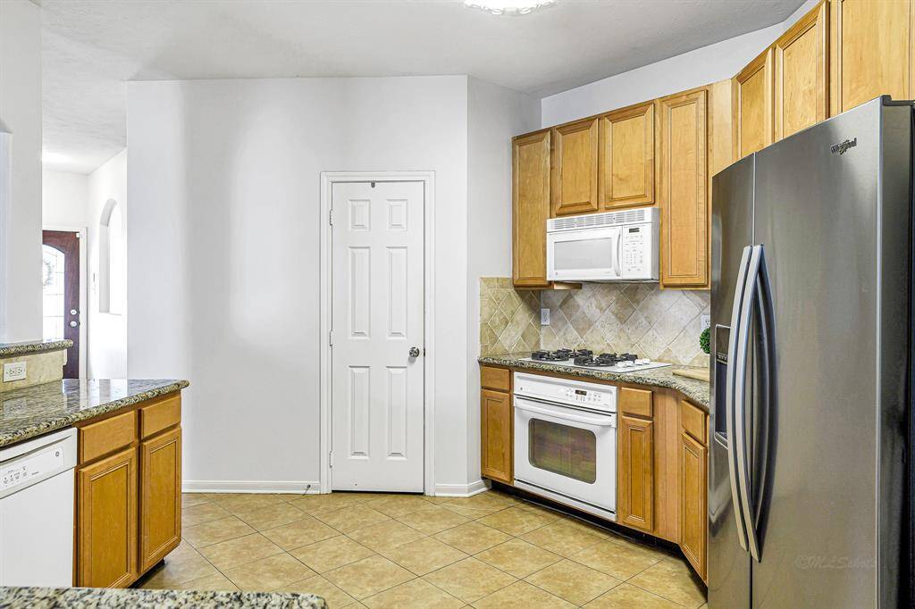 Centrally located, this kitchen seamlessly connects the dining room, living room, and breakfast room, offering both convenience and functionality. Plus, enjoy the added bonus of a spacious pantry!