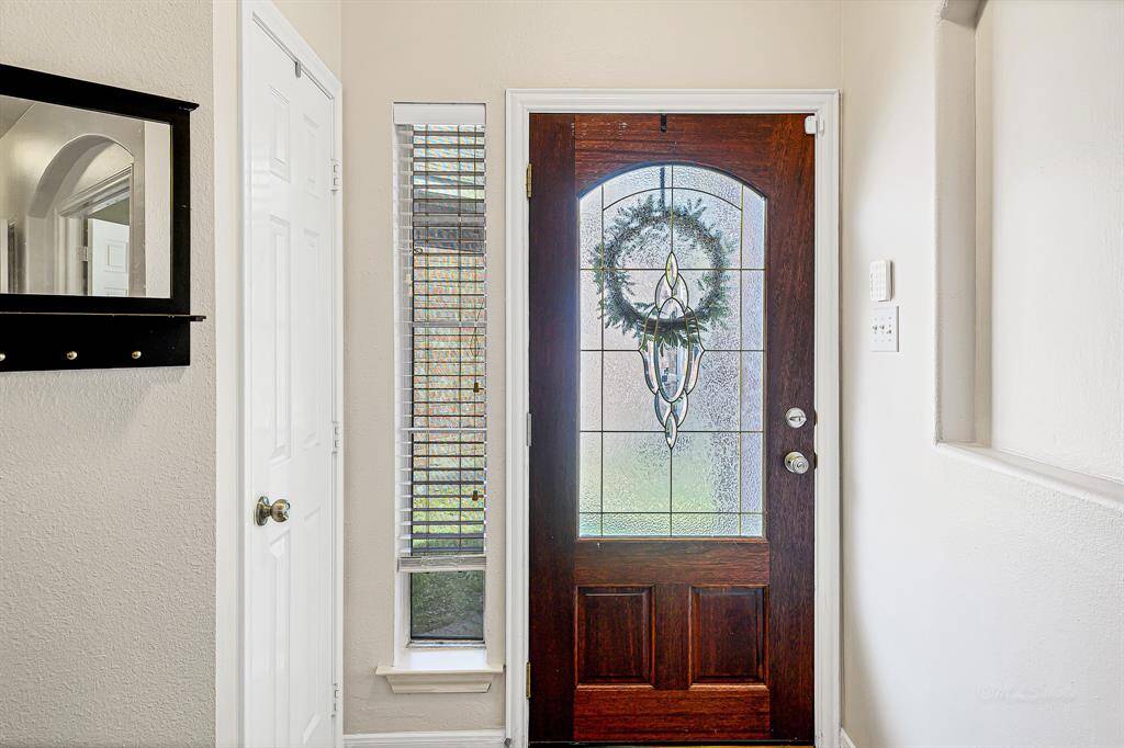 Step through the elegant leaded glass front door with a transom window and into the warmth of your new home. The space is bathed in natural light! A deep coat closet near the entry provides convenient storage forguests and everyday essentials.