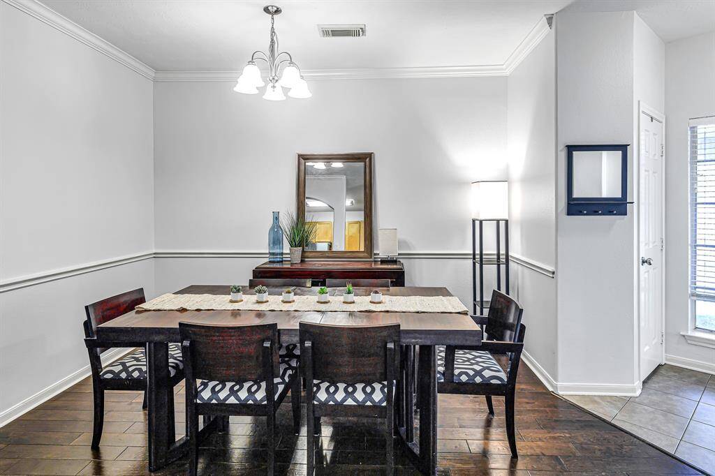 Continuing from the entryway, you are welcomed into theelegant dining area, where engineered hardwood floors flowseamlessly throughout. Soaring 9-foot ceilings, crown molding, and a classic chair rail addtimeless sophistication.