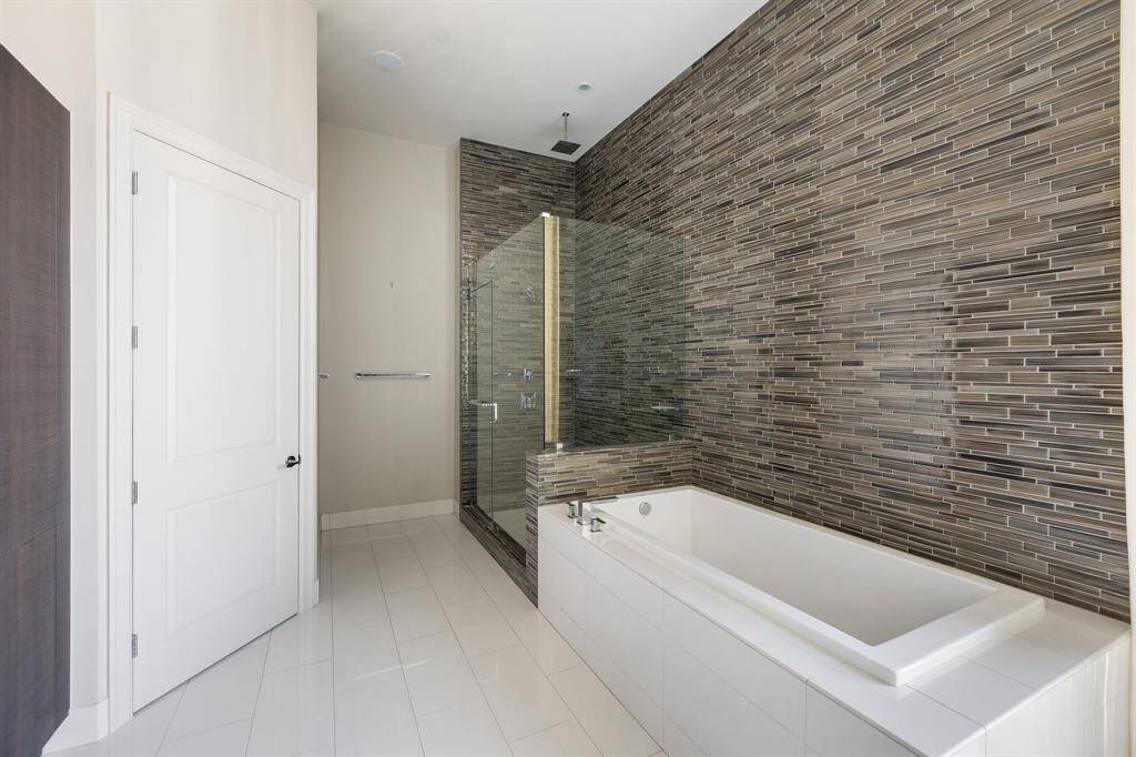 Glass enclosed shower and tub pictured here.