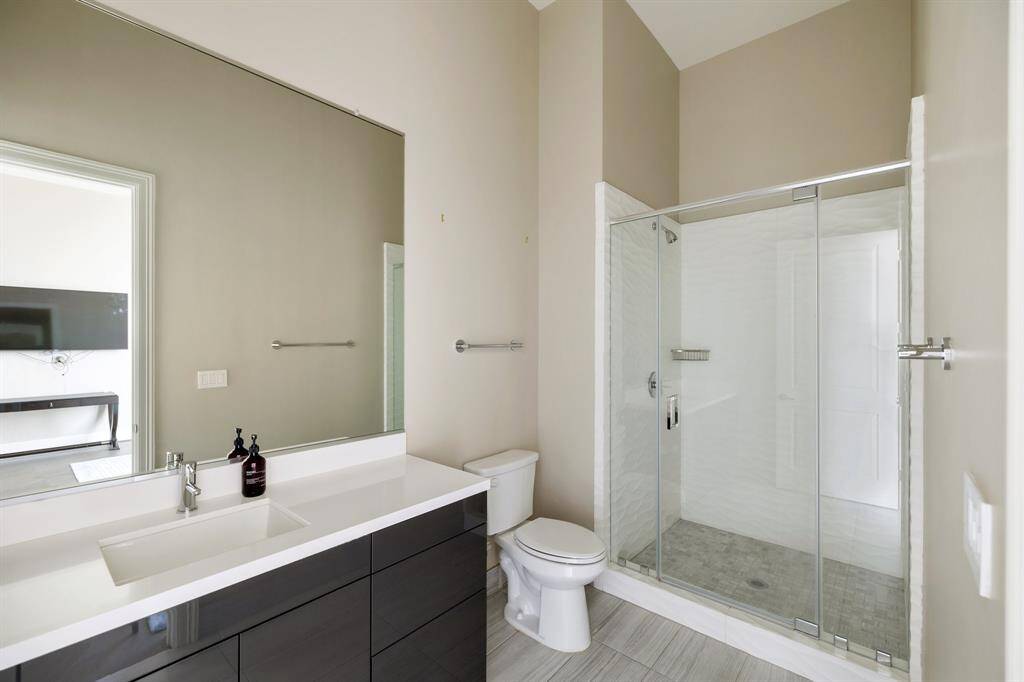 Full bath with glass enclosed shower.