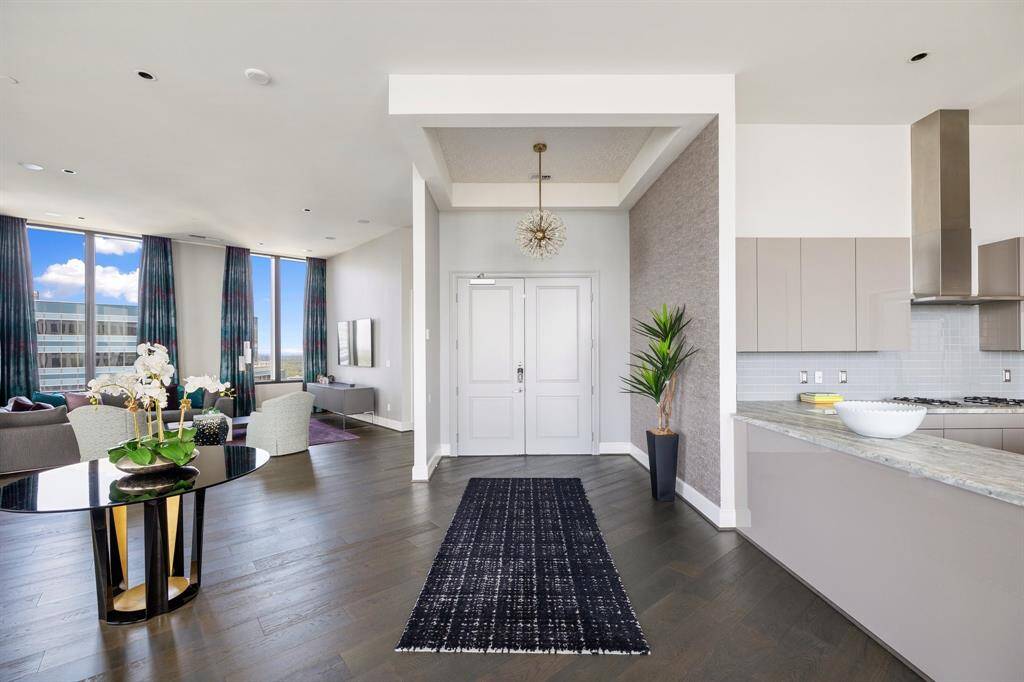Double doors, 12 ft ceilings, and hardwood floors welcome you to the home.