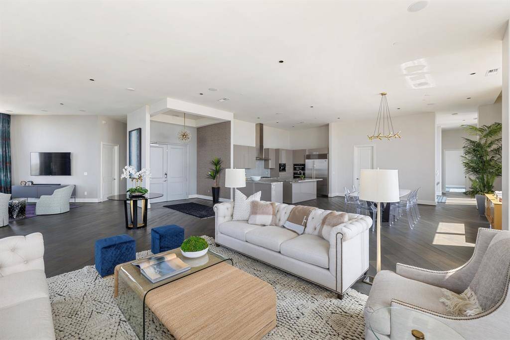 The kitchen, dining, and living spaces flow cohesively in an open concept floor plan.
