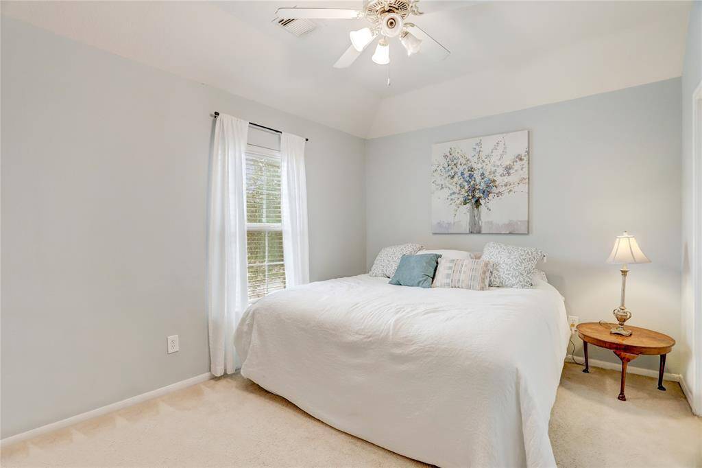 CHARMING GUEST BEDROOMWITH SOFT NEUTRAL TONES,VAULTED CEILING, AND ALARGE WINDOW THAT FILLSTHE ROOM WITH LIGHT.