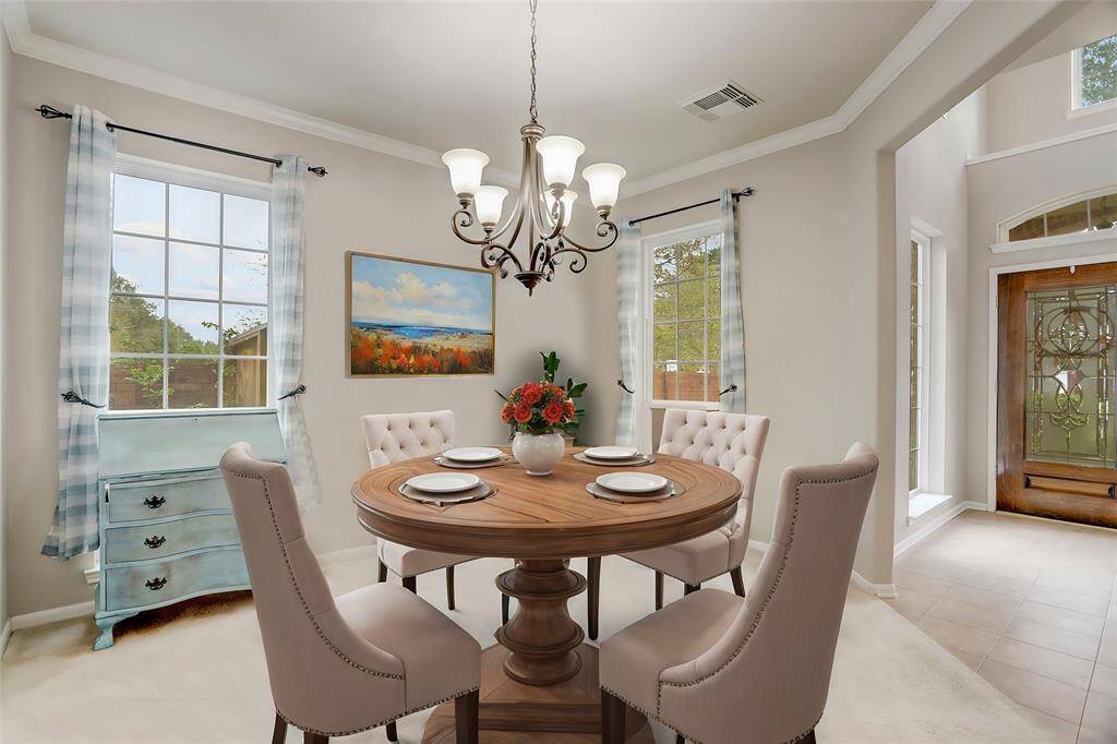 ELEGANT FORMAL DININGROOM FEATURING CROWNMOLDING, NATURAL LIGHT,AND A CLASSIC CHANDELIERFOR A TIMELESS DININGEXPERIENCE. ***This photohas been virtually staged.