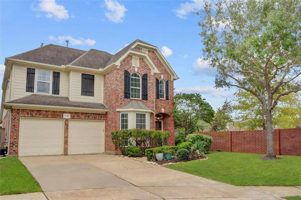 A SPACIOUS DRIVEWAYLEADS TO A TWO-CARGARAGE, COMPLEMENTEDBY MATURE TREES AND AFULLY FENCED BACKYARDFOR PRIVACY.