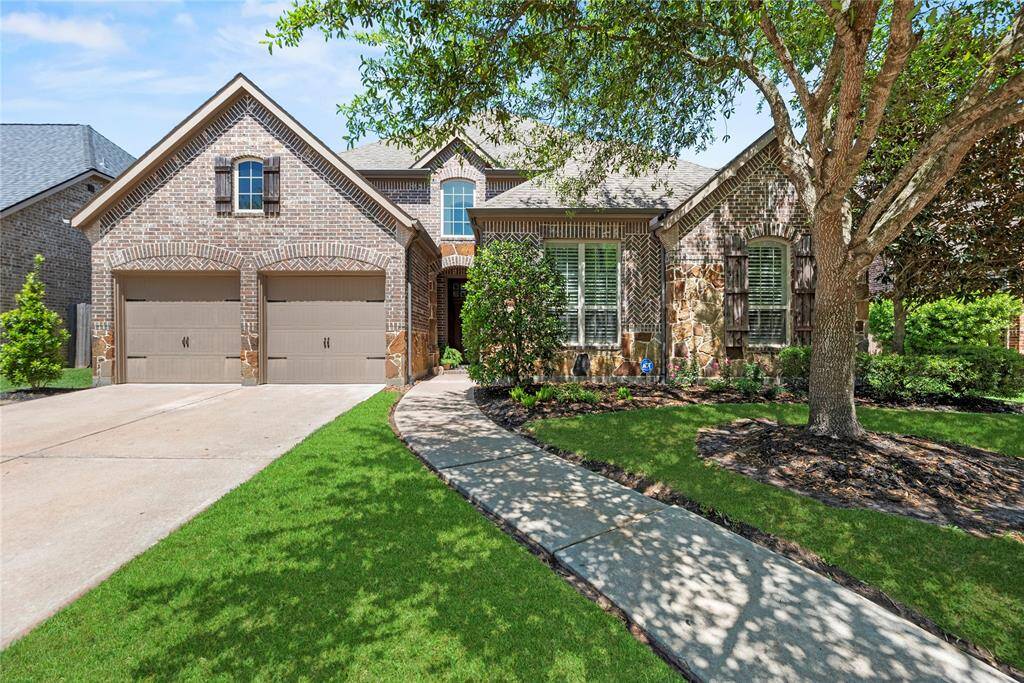 Welcome home to 15019 Turquoise Mist Drive in the charming Fairfield Village community in Cypress.