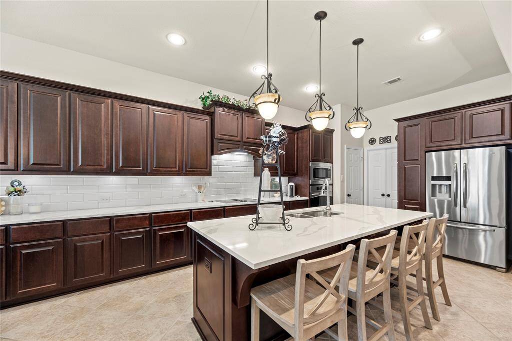 Rich cabinetry offers a clean, timeless aesthetic that elevates the space with a sense of brightness and openness.