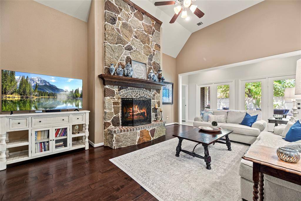 The inviting center fireplace becomes a focal point that anchors the room and invites people to gather and linger, making it a cherished feature of the living area.