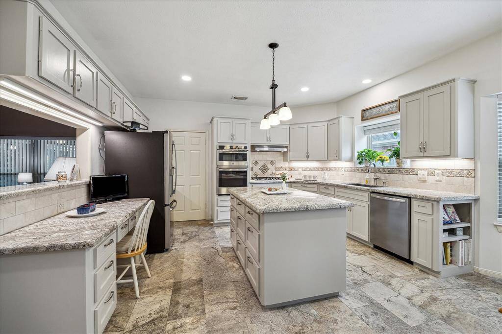 This gorgeous island kitchen has storage in the island, cabinets and even up high!