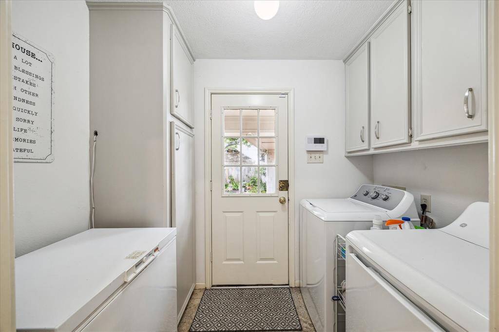 The laundry room has plenty of room for a second frig.